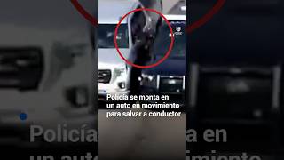 Policía se monta en un auto en movimiento para salvar a conductor