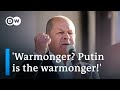 German Chancellor Scholz throws angry response at chants of 'warmonger' | DW News