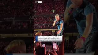 Chris Martin helps boy at Coldplay concert