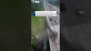 Moment lorry falls off highway