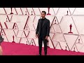 British actor Riz Ahmed fixes his wife's hair at the Oscars