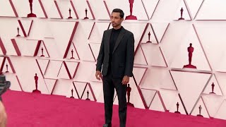 ROUGH RICE British actor Riz Ahmed fixes his wife&#39;s hair at the Oscars