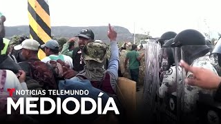 Migrantes de una caravana se abren paso a empujones y golpes ante un piquete de la Guardia Nacional