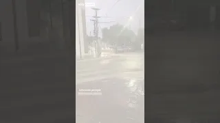 Man bikes through heavy flood waters