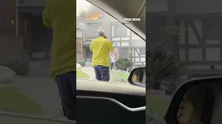 Man rescues American flag from stranger&#39;s yard as home burns behind him