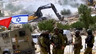 Israeli bulldozers demolish most of a West Bank Bedouin hamlet displacing dozens of Palestinians