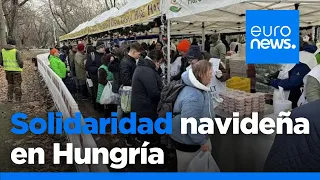 Miles de personas reciben alimentos y platos calientes en una campaña benéfica navideña en Bu…