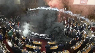 Serbia&#39;s parliament session erupts into chaos as opposition MPs set off flares and smoke grenades