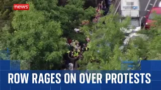 Row rages on over migrant protests