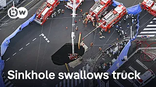 Search underway for Japanese man after truck falls into sinkhole | DW News