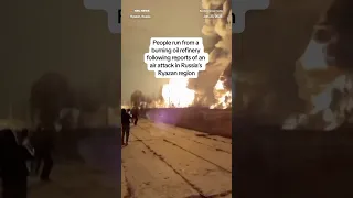 People run from a burning oil refinery following reports of an air attack in Russia&#39;s Ryazan region