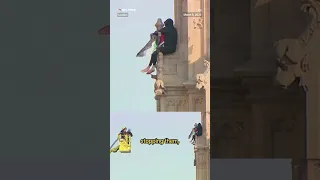 Man climbs Big Ben while holding Palestinian flag